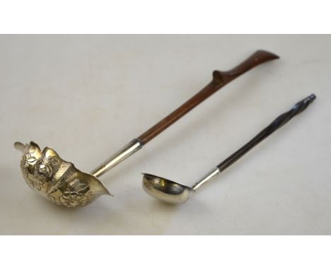 A George II silver punch ladle, the double-lipped ogee bowl with floral and foliate embossing, on carved wood stem, Maker WK 