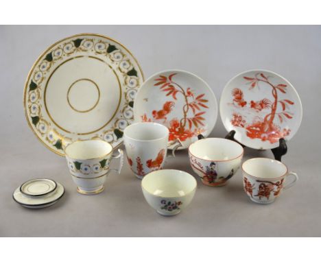 An early 19th century porcelain teacup and two saucers painted in iron red and gilt with fighting cockerels, impressed mark t