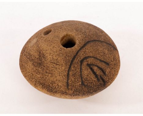 Ian Godfrey (1942-1992), a stoneware pebble form with textured body with dry brown mottled glaze and incised linear markings 