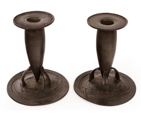 Archibald Knox for Liberty and Co., a pair of English pewter candlesticks, circa 1900, model 0221, marked to base, 14.5cm hig