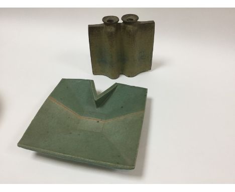 A 20th Century pottery twin-candlestick holder in rough cream, blue and iron glaze, impressed mark B, 19cm wide and a pale gr