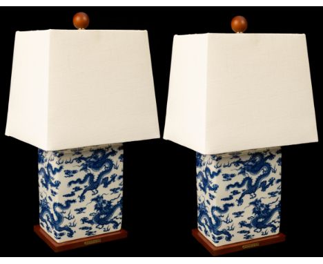A pair of Lauren table lamps, the rectangular ceramic bases with Oriental dragon design on a wooden base, tapered rectangular