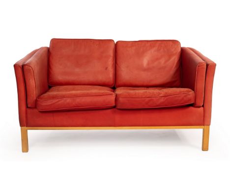 A Danish Stouby red leather two-seater sofa, with label, 145cm wide CONDITION REPORT: Leather faded, stained in places and wi