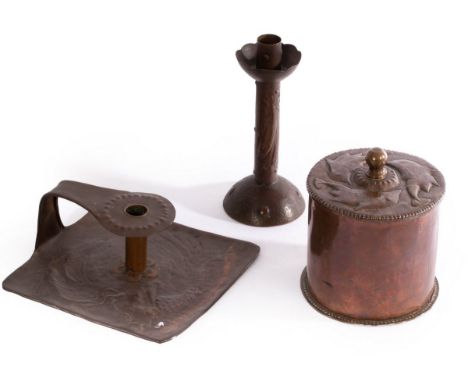 Newlyn, a copper candlestick embossed fish, stamped, 20.5cm high, a copper biscuit barrel, the cover embossed stylised dolphi