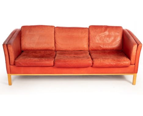 A Danish Stouby red leather three-seater sofa, with label, 208cm wide CONDITION REPORT: Leather faded, stained in places and 