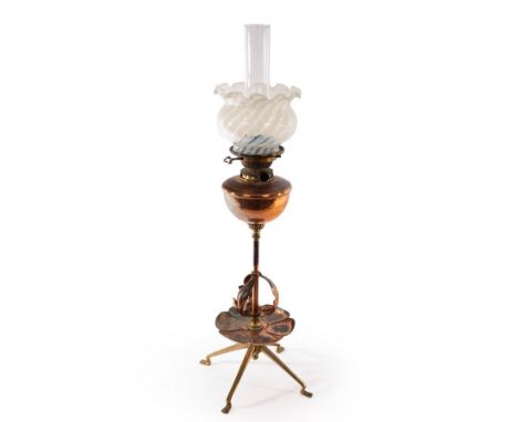 Attributed to WAS Benson, a copper and brass oil lamp, with copper petal and foliate decoration, on four feet, the wick adjus