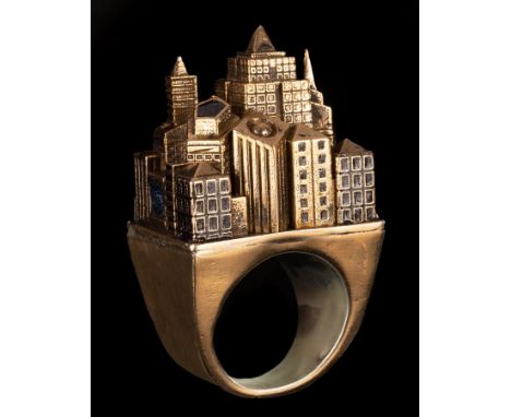 A silver gilt and enamel architectural ring, modelled as a city, marked 925 CONDITION REPORT: Size W-X. Overall condition loo
