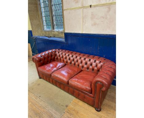 A red leather Chesterfield sofa, 200 cm wideSome ware to the leather. some claw marks probably cat  to arms, seat firm. 