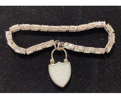 A silver and opal line bracelet, with an opal locketModern 