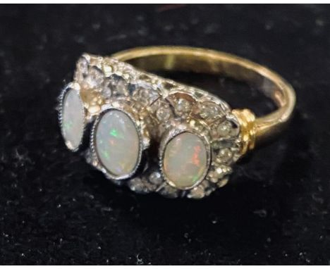 A 9ct gold, three oval stone opal and diamond ringModern 