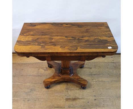 A 19th century rosewood folding card table, on a carved support shape base with bun feet, 92 cm widevey slight bow/smile to t