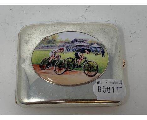 A silver cigarette case, later applied a plaque decorated cyclists racing 