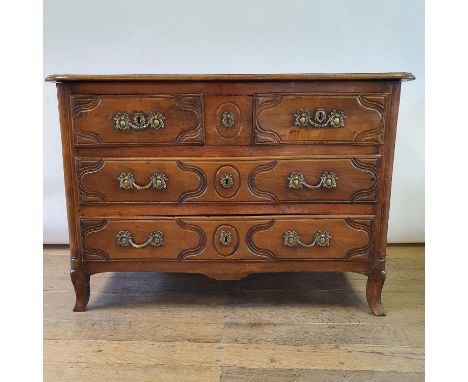 A French early 19th century serpentine front walnut commode, having two short and two long drawers, 126 cm wide 