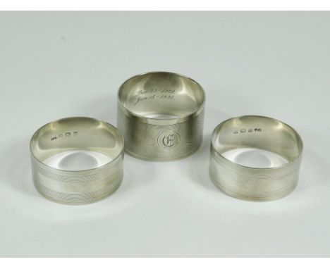 NAPKIN RINGS. Three engine turned napkin rings.  Please note that all items in this auction are previously owned & are offere