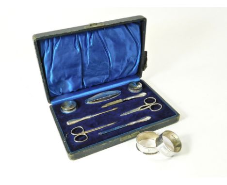 MANICURE SET ETC. A 1920's silver mounted manicure set in fitted case. Birmingham 1922. (Both sets of scissors with damaged b