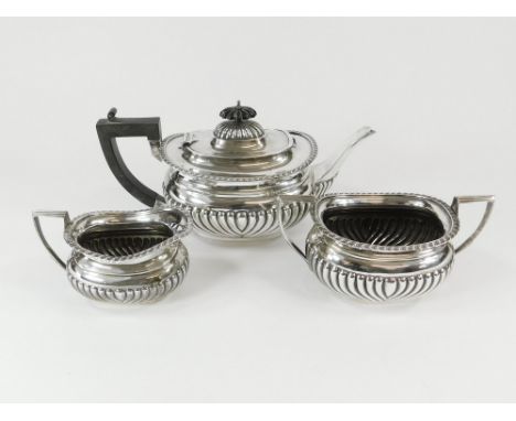TEA SERVICE. An Edwardian silver, half fluted three piece tea service by William Aitken. Birmingham 1908. Approx. 1175.3g. (3