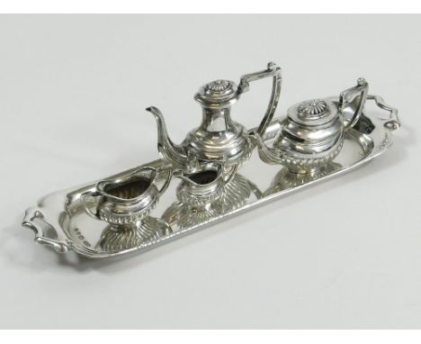 MINIATURE TEA SERVICE. A miniature silver, four piece tea & coffee service with twin handled long tray. Birmingham 1970. Leng
