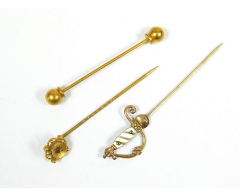 STICK PINS. A ruby set stick pin, a white metal & mother of pearl 'sword' stick pin & a gilt metal collar pin.  Please note t