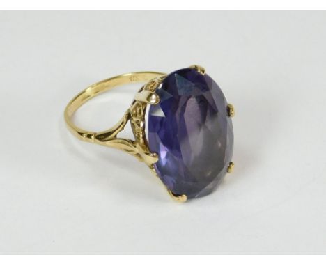 GOLD RING. A 9ct. gold dress ring, set a large oval amethyst in a coronet setting. Size of stone 2.1 x 1.4cm.  Please note th