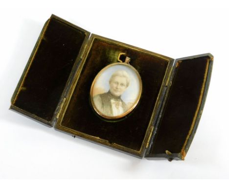 PORTRAIT MINIATURE. A portrait miniature painted on ivory, initialled AMW. To the reverse, the backing paper inscribed in pen