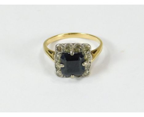 SAPPHIRE RING. A yellow metal, square sapphire & diamond cluster ring (Indistinctly stamped). Size K.  Please note that all i