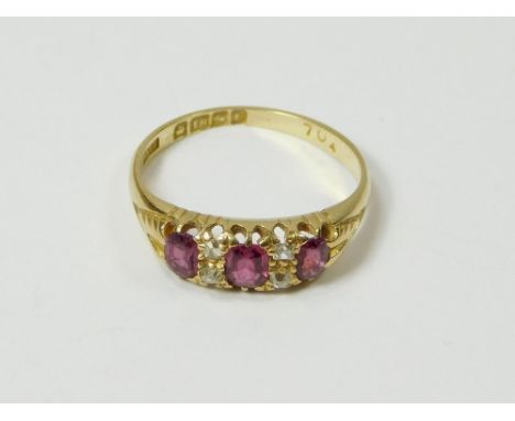 GOLD RING. An early 20th century, 18ct. gold ring, set two oval & one cushion-cut ruby & four small diamonds. Size M/N.  Plea