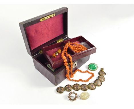 JEWELLERY BOX & CONTENTS. A small leather jewellery box containing a string of stick coral, an enamelled brass bracelet, a ca