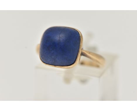 A LAPIS LAZULI RING, designed as a square lapis lazuli cabochon in a collet setting to the plain band, stamped 9ct, ring size