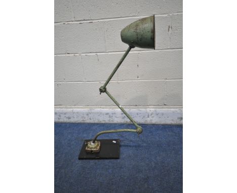 A GREEN VINTAGE INDUSTRIAL WORK LAMP, with two angled joints, on a later wooden base (condition report: rusty finish, in need