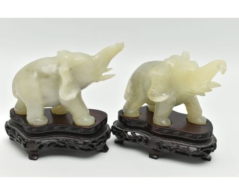 A PAIR OF MODERN CARVED JADE ELEPHANT FIGURINES, each with a molded wooden plinth, approximate height of each off their plint