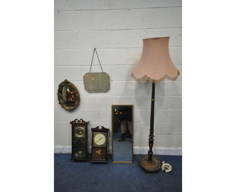 A FOLIATE GILT RESIN WALL MIRROR, two other mirrors, two wall clocks and a standard lamp (condition report: some staining due