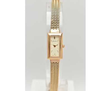 A LADY'S 9CT GOLD ACCURIST WRISTWATCH, the rectangular cream face with gold colour baton markers and hands to the expandable 