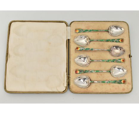 A CASED SET OF SIX ENAMEL SILVER TEASPOONS, each decorated with a green enamel floral stem and flower for the handles, each h