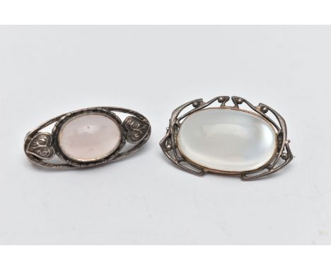 TWO BROOCHES, the first of an oval form, set with an oval cut moonstone cabochon, open work surround, fitted with a brooch pi