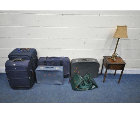 FIVE VARIOUS SUITCASES, a green Jaguar carry back, a 20th century oak sewing box and a table lamp (condition report: surface 