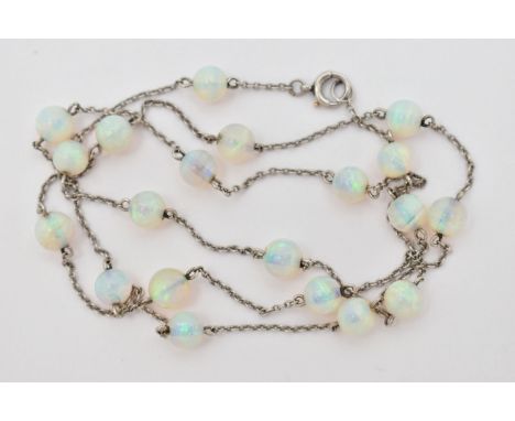 A WHITE METAL OPAL BEAD NECKLACE, twenty opal beads each interspaced and fitted to a fine white metal trace chain, with sprin