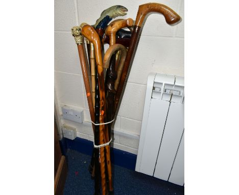 A GROUP OF THIRTEEN WALKING STICKS, comprising a novelty hand painted stick with a carved 'Salmon' handle, a Stormafit cane, 