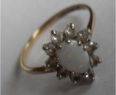 A 9ct gold ring with drop-shaped opal cluster surrounded by ten cubic zirconia, size L, 1g approx 