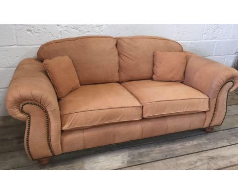 A Thomas Lloyd three-seater leather-upholstered sofa with carved arms on turned legs, 205 x 70 x 94 cm
Condition: Light even 