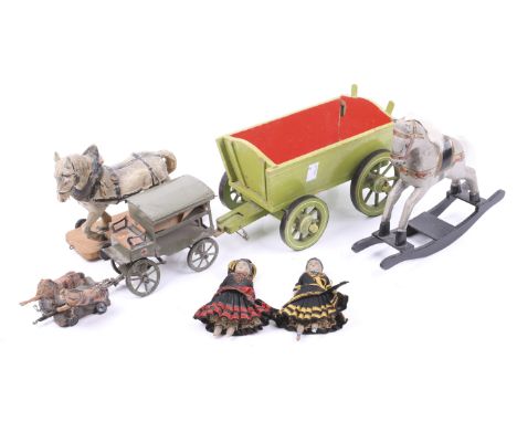 A collection of Elastolin German vintage toys. Comprising a horse mounted on a wooden base with wheels, a green wooden cart a