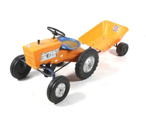 A Triang childs pedal tractor and trailer. A blue metal chassis with plastic orange body, hard plastic tyres and blue metal s