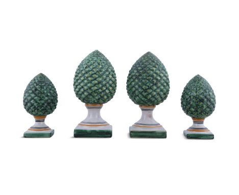 A SET OF FOUR PINEAPPLE FINIAL DECORATIVE ORNAMENTSpainted green, each signed 'G. Judici Caltagirone'. Largest 20cm high, sma