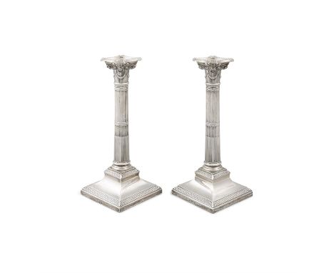 A PAIR SILVER CORINTHIAN COLUMN CANDLESTICKS AND SCONCESLondon c.1898, mark of William Hutton & Sons Ltd. with banded taperin