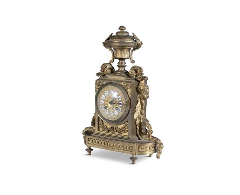 A FRENCH GILT METAL MANTLE CLOCK, LATE 19TH CENTURYsurmounted with a classical urn, over a gilt metal dial with enamelled num