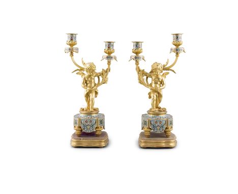 A PAIR OF LATE 19TH CENTURY FRENCH ORMOLU FIGURAL CANDELABRA each putto supporting a branch with two candle sconces with cham