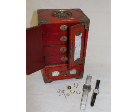 A modern Chinese table top jewellery cabinet with pierced brass embellishments containing a tigers eye and diamond set dress 