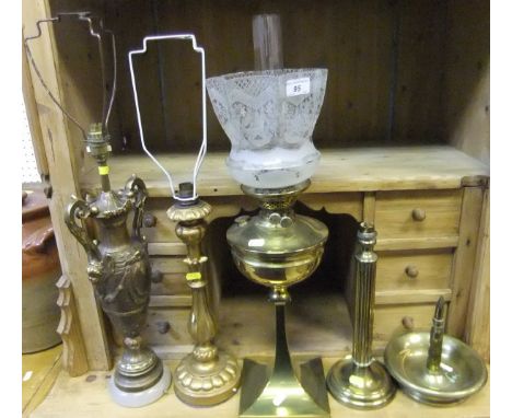 A Victorian brass bodied oil lamp with clear glass chimney and etched glass shade, raised on a square base, together with a b