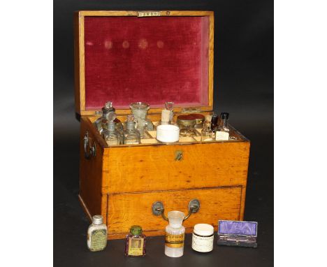 A 19th century oak chemist's / pharmacist's travelling medicine cabinet, the rising lid opening to reveal fitted compartments