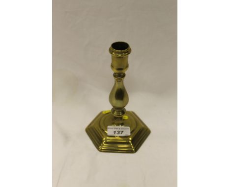 An 18th Century brass candlestick of hexagonal form