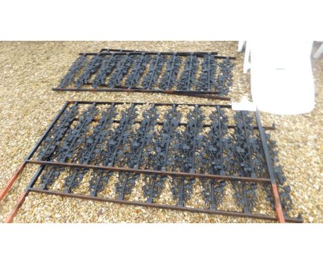 Four painted wrought iron railing sections, each decorated with grapes and vines